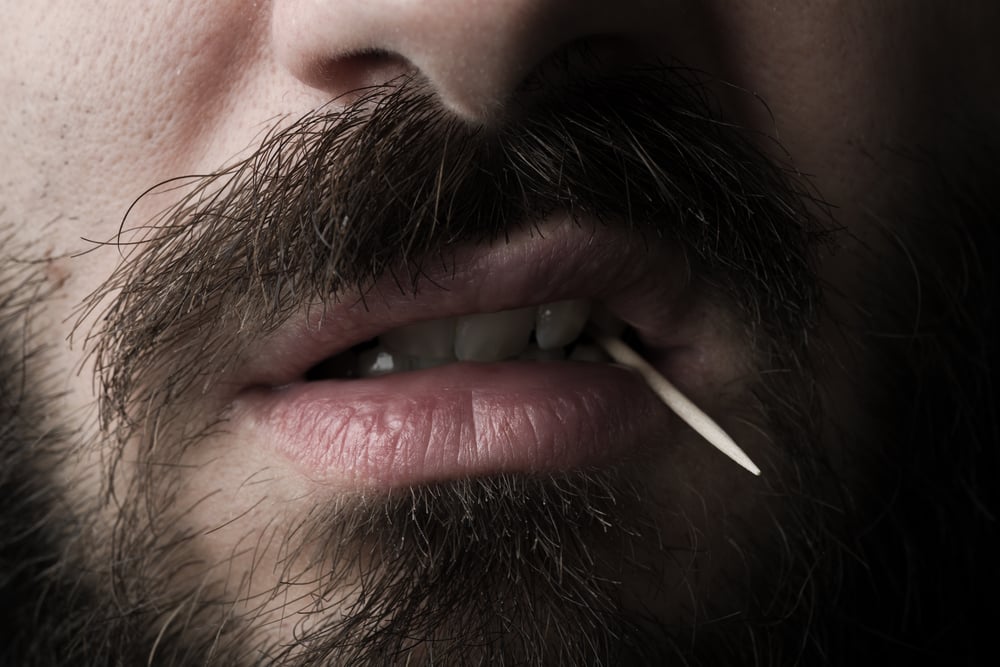 close-up-of-man-with-dark-beard-and-toothpick