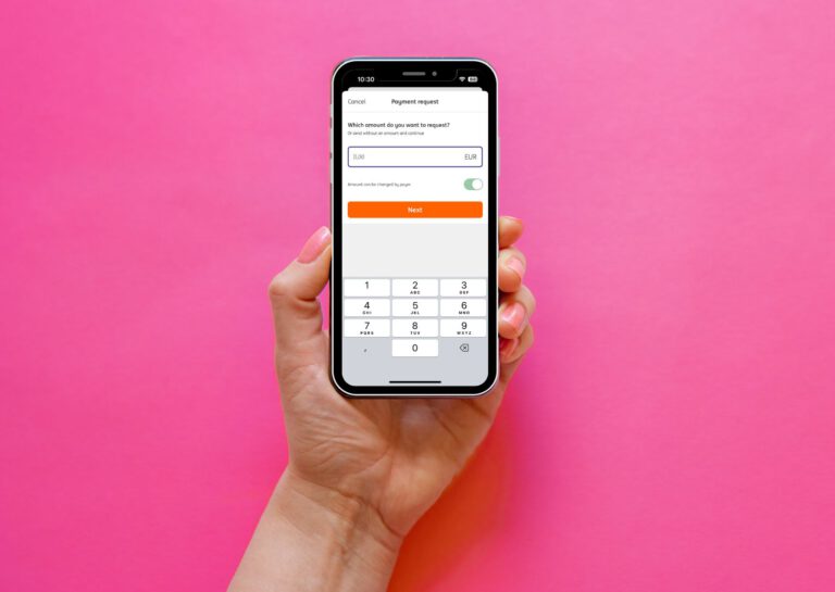 ING-payment-request-on-phone-in-hand-in-front-of-pink-bankground