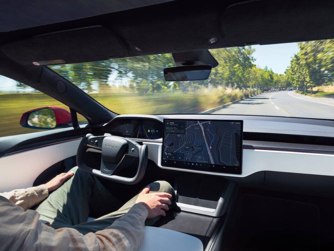 photo-of-tesla-model-s-interior-with-hands-free-driving-activated-zooming-down-country-road