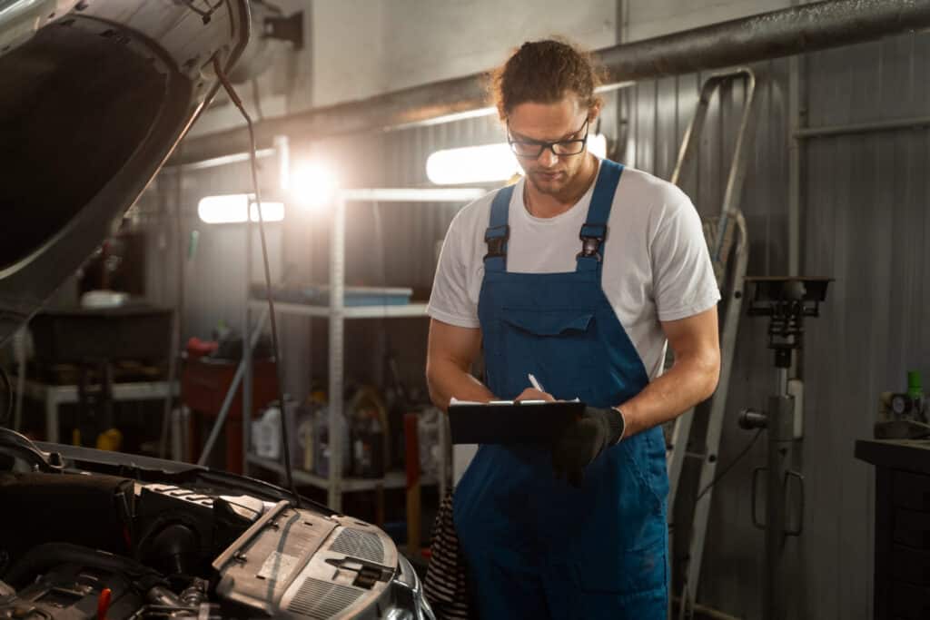 photo-of-mechanic-checking-list-as-he-carries-out-periodic-motor-vehicle-test-in-the-Netherlands