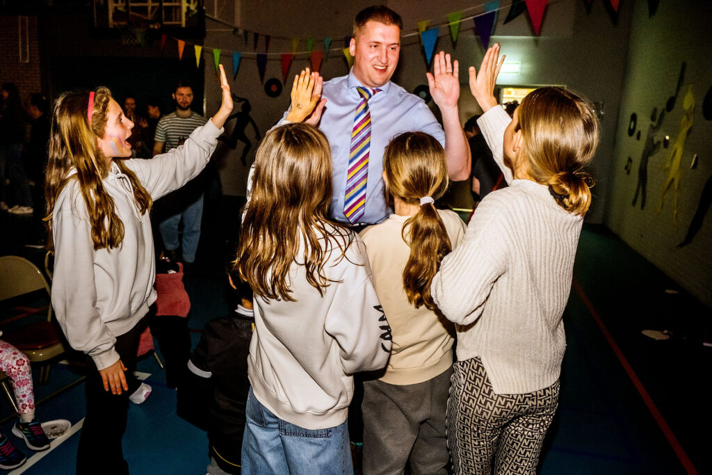 NAISR-international-school-rotterdam-staff-with-students-giving-high-fives