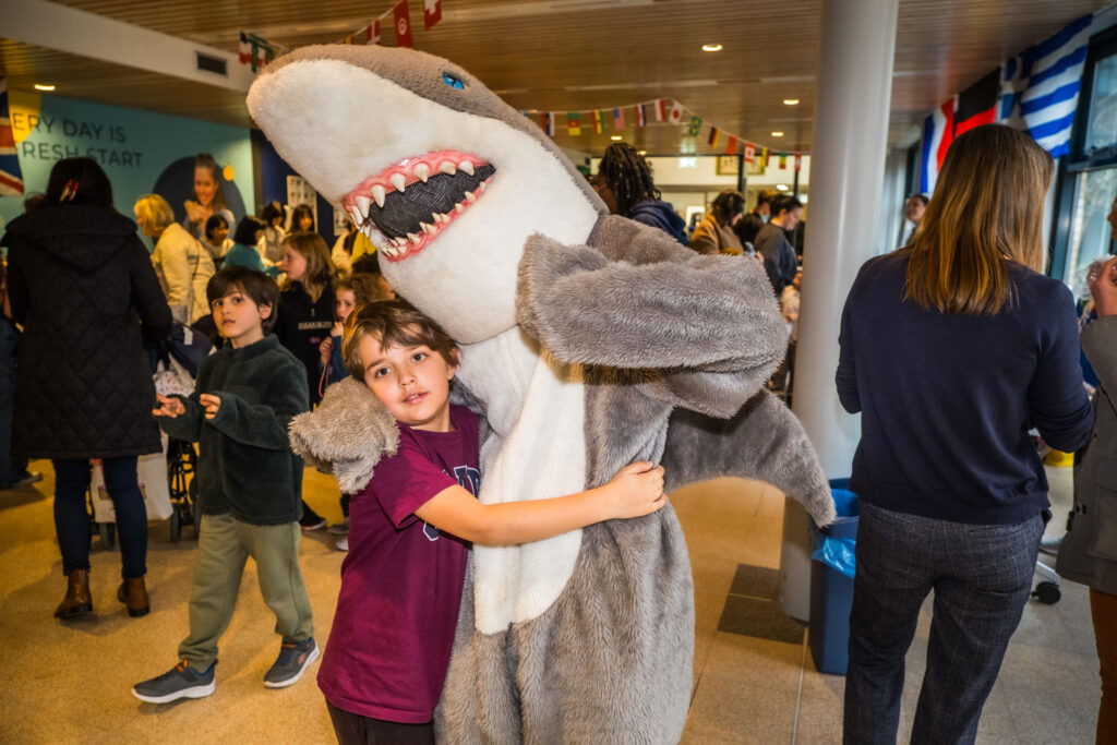NAISR-international-school-Rotterdam-student-hugging-school-mascot-shark