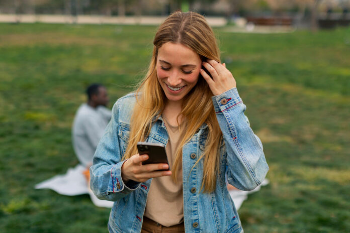 photo-of-woman-smiling-down-at-phone