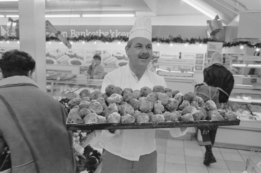 photo-of-man-holding-tray-of-oliebollen