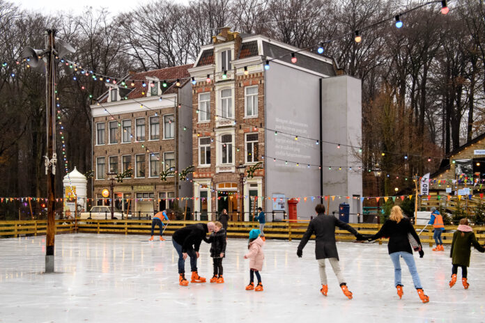 Ice rink illuminated with festive lights at night