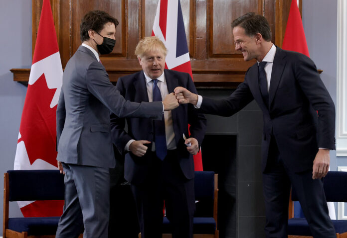 prime-ministers-rutte-trudea-and-johnson-greeting-one-another