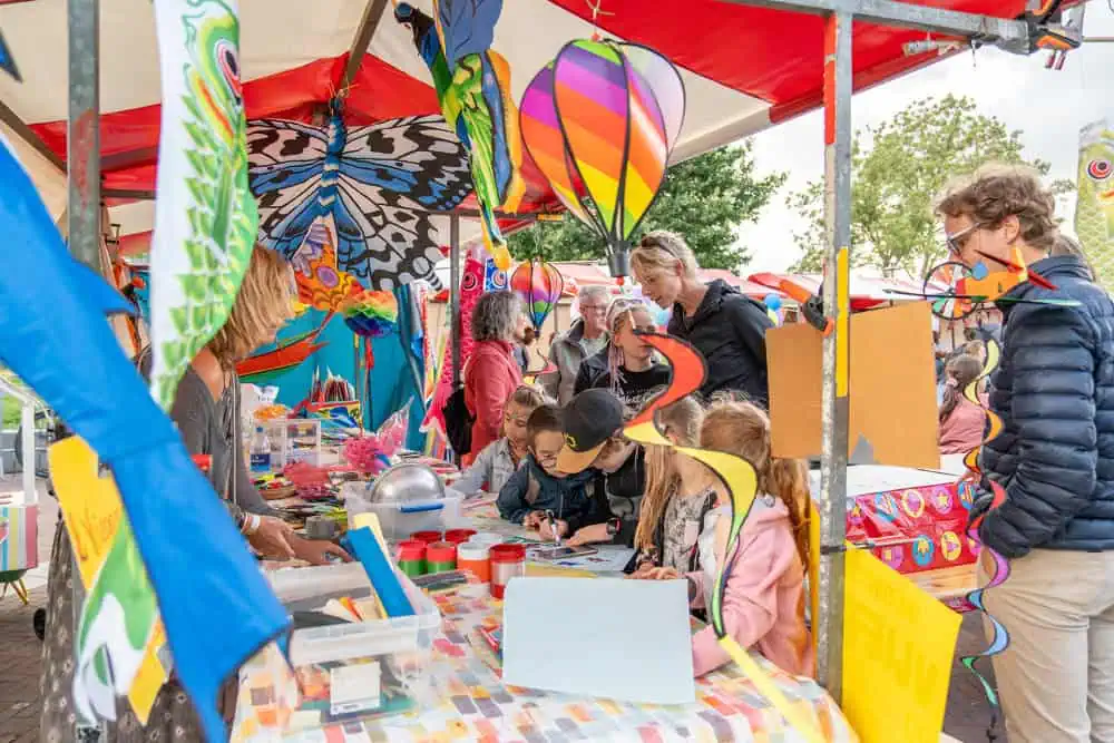 a group of children and parents at a market stall at pasar in leiden the Netherlands