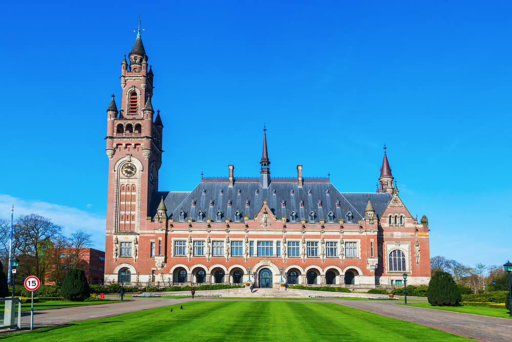 photo-of-peace-palace-in-the-hague-against-backdrop-of-bright-blue-sky