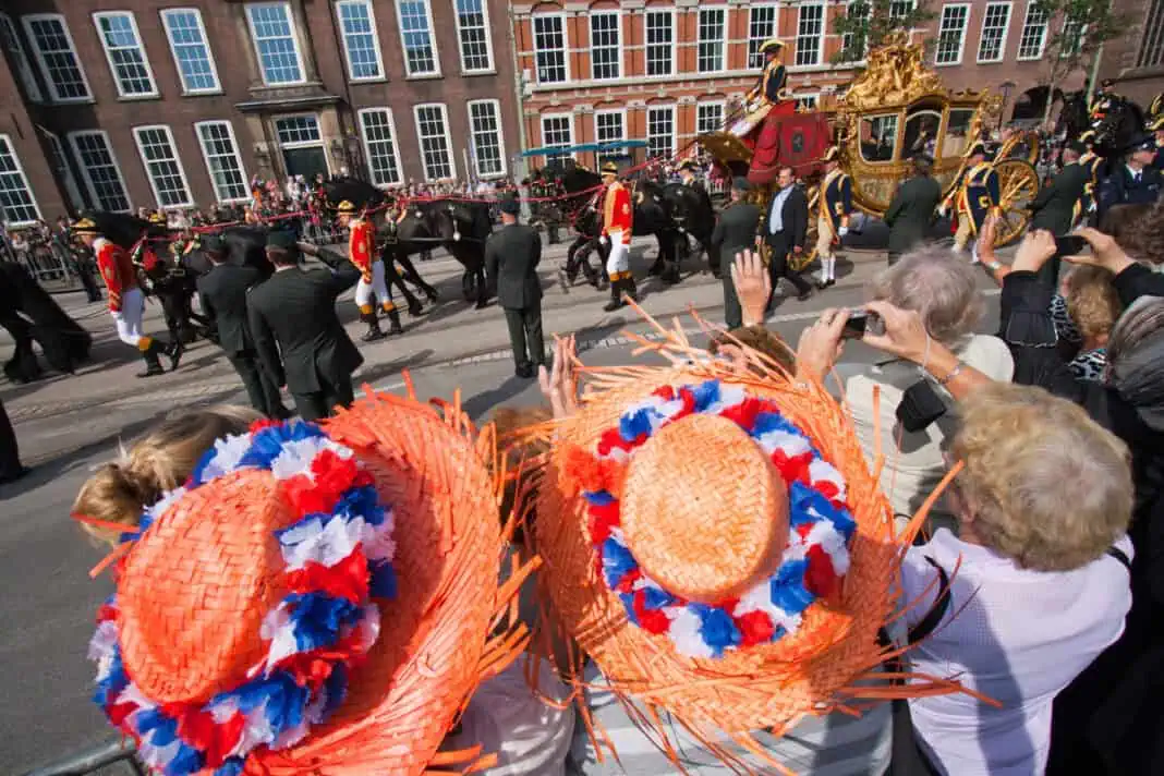 photo-of-people-on-Kings-day-in-orange-Dutch-hats-waving-taking-photos-of-royal-family-passing