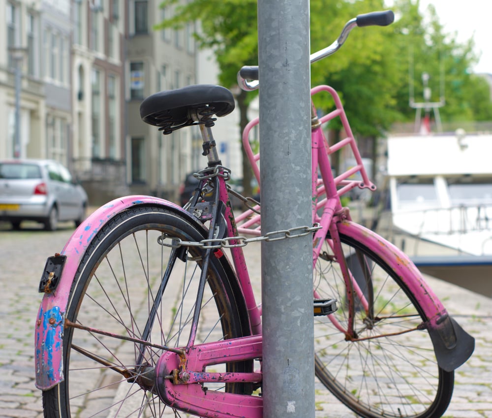 pink-bicycle -locked-on-a-lamp-post-in-Groningen-Netherlands