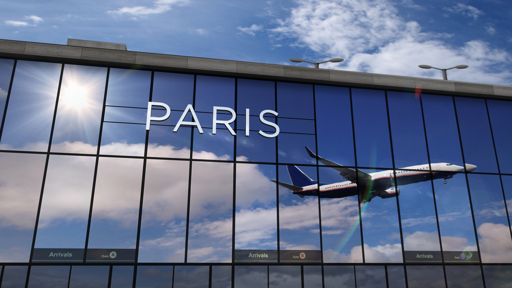 Reflection-of-landing-airplane-in-paris-airport-building
