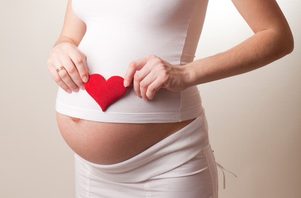 pregnant-woman-holding-heart-above-belly