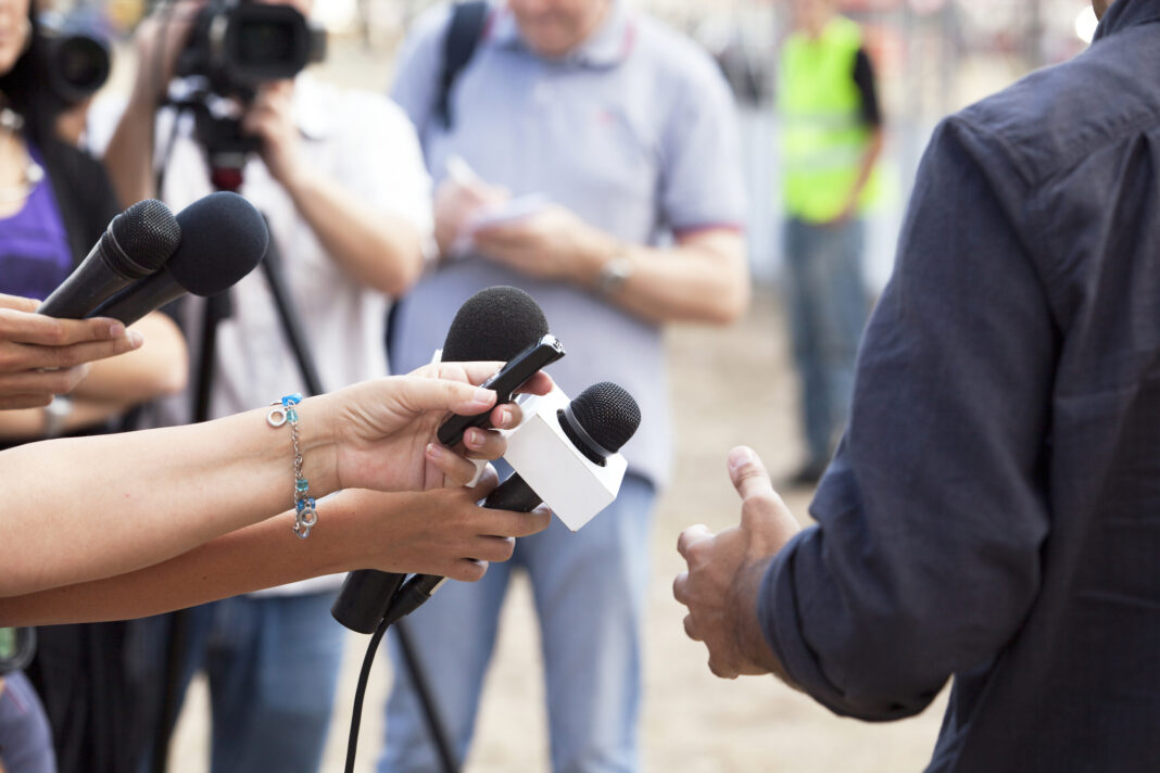 Person-being-interviewed-by-a-press-team