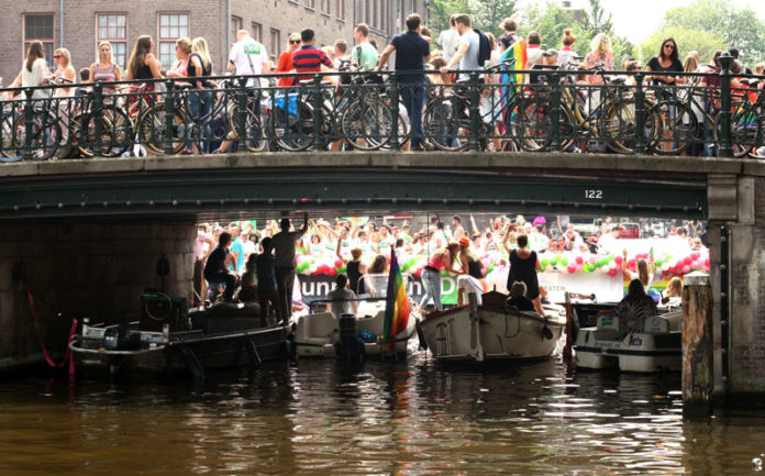People on a canal at Pride Parade in Amsterdam.