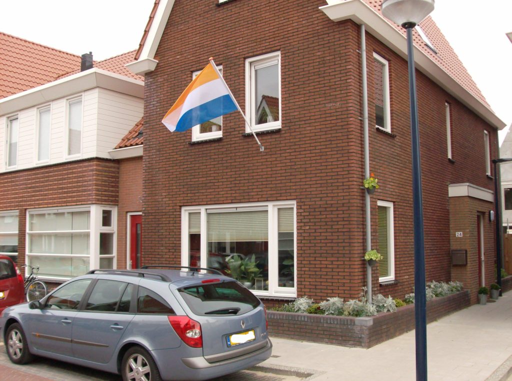 Prinsenvlag-Dutch-flag-flying-outside-of-Dutch-house-in-the-Netherlands