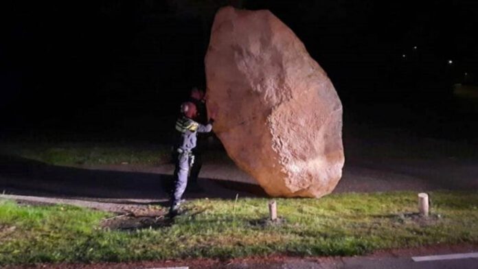 Photo-of-policeman-holding-fake-boulder
