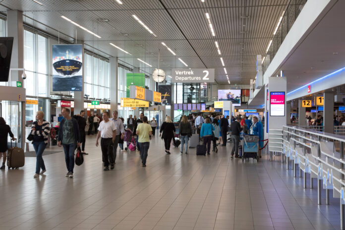 Inside-Schiphol-airport-departure-with-passengers-walking-around