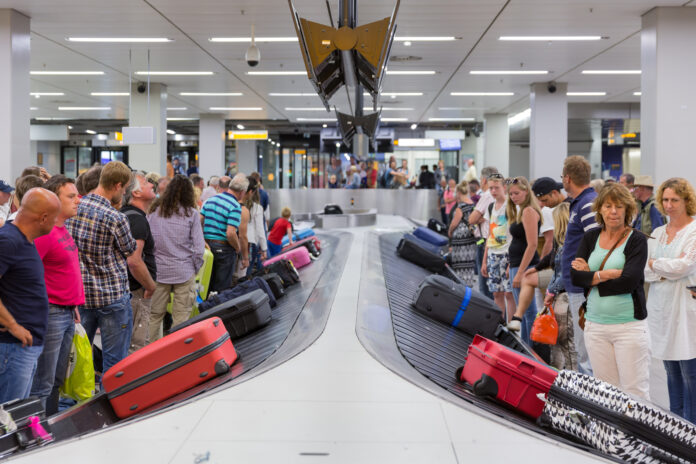 Traveller-getting-their-luggage-from-baggage-claim-in-Schiphol-Airport