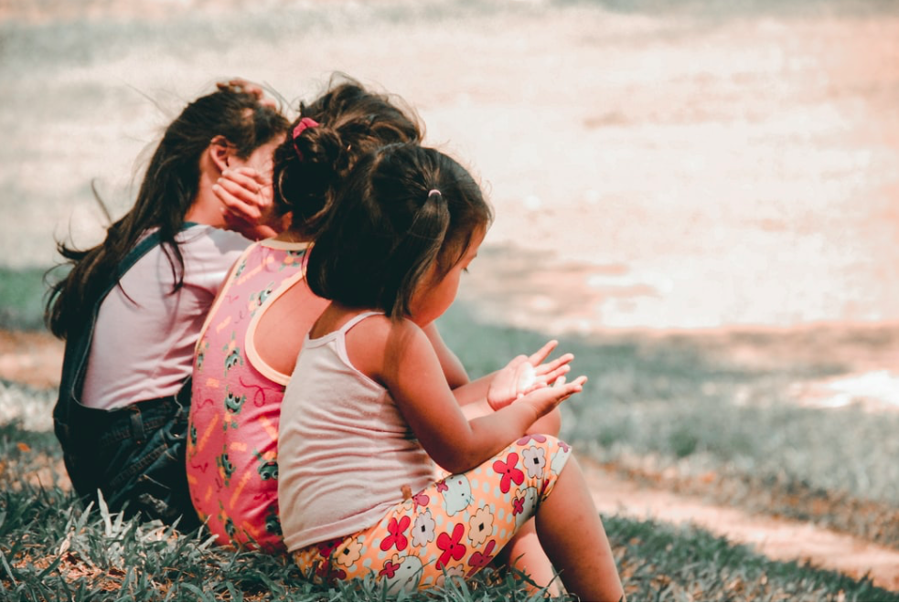 Photo-of-children-sitting-in-park