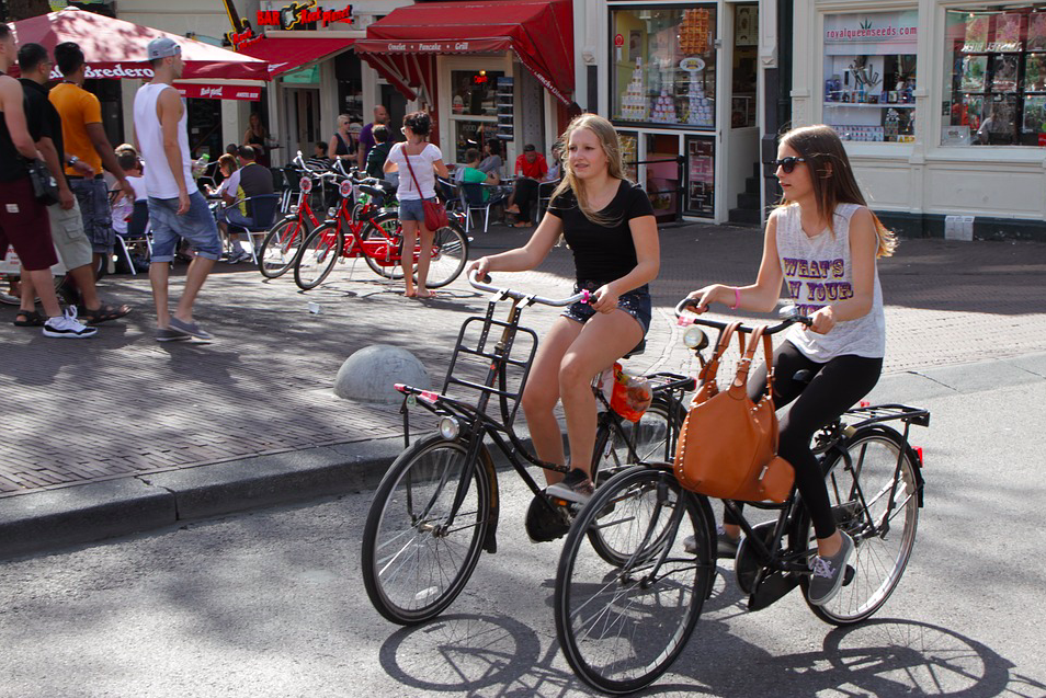 Girls-biking-in-the-city-centre-of-amsterdam-the-netherlands