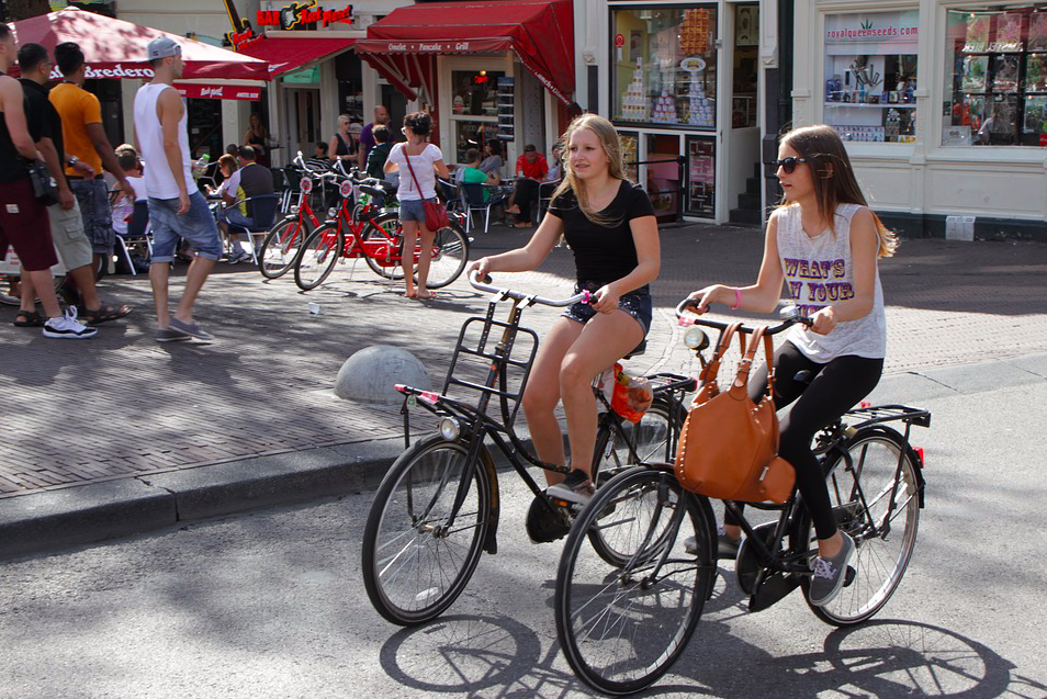 two-girls-cycling-in-amsterdam