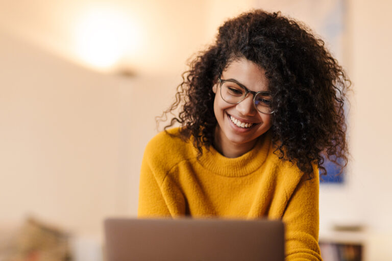 Photo-of-woman-smiling-down-at-laptop