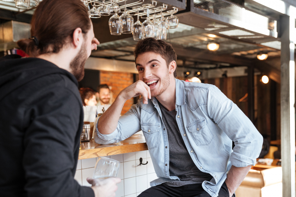 Photo-of-two-friends-at-bar-talking