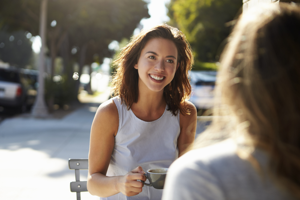 Photo-of-woman-talking-to-friend-over-coffee-about-job-hunt