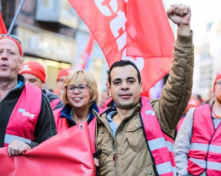 Dutch-man-holding-up-fist-while-on-strike-on-Dutch-labour-day