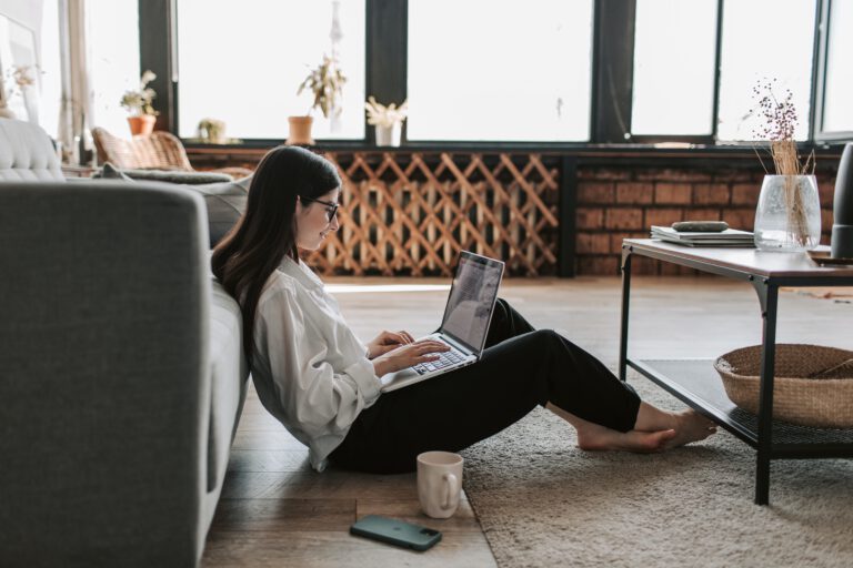 Female-student-working-on-laptop-in-furnished-apartment