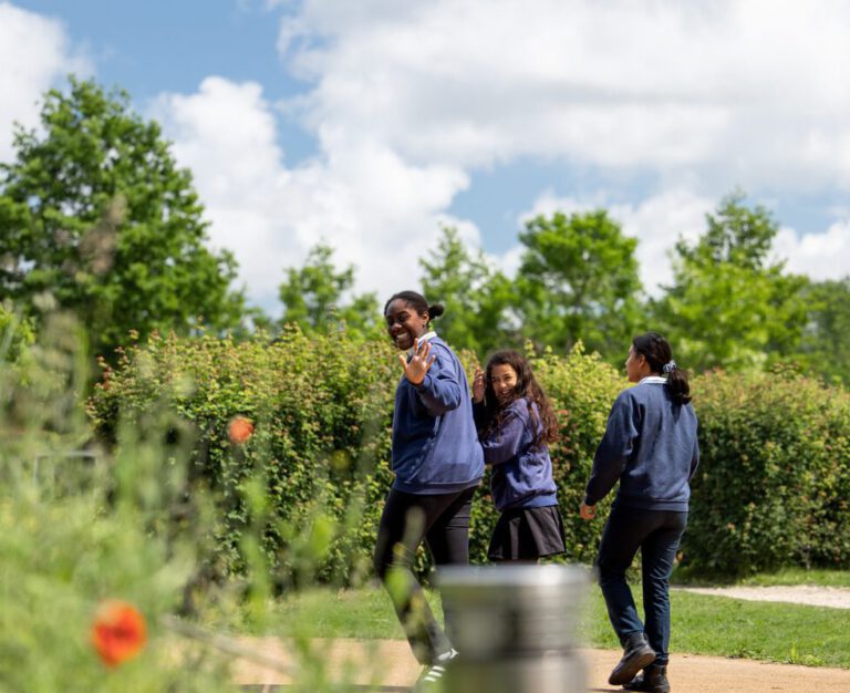 Three-students-walking-outdoors-at-the-British-school-in-the-Netherlands