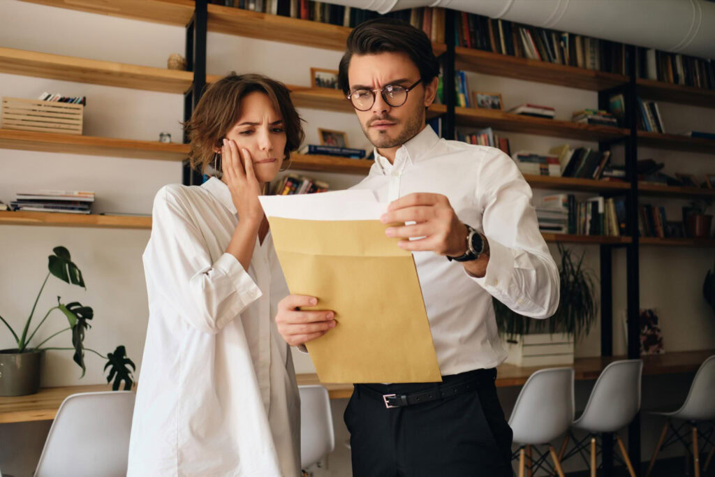 photo-of-man-and-woman-looking-confused-at-papers-detailing-summary-dismissal-in-the-Netherlands