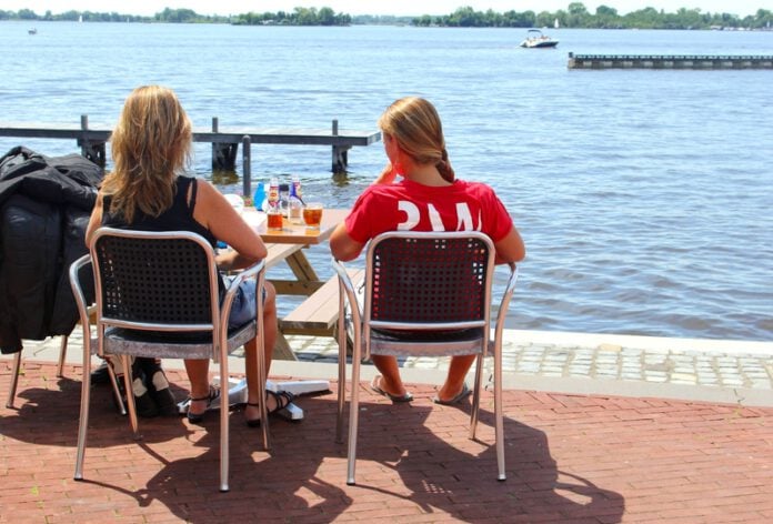 photo-of-women-sitting-in-sun-next-to-canal-Netherlands