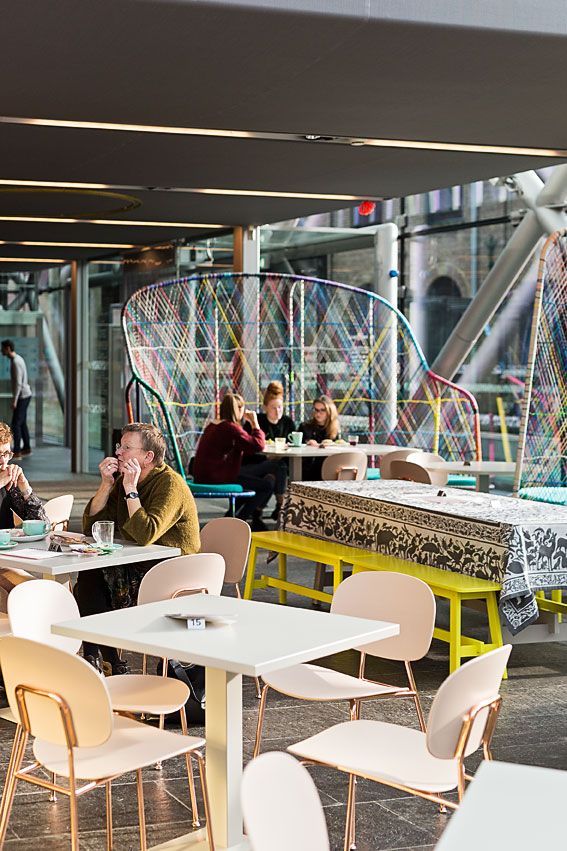 People sit in a bright cafe at the TextielMuseum