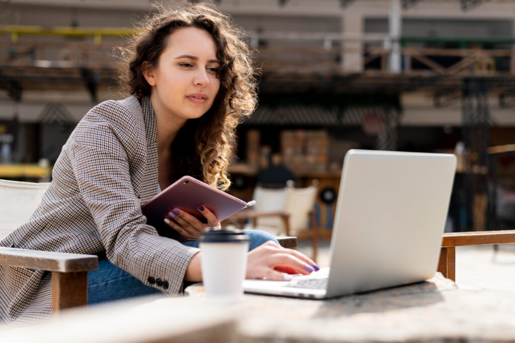 photo-of-woman-studying-for-the-Dutch-integration-exams-with-laptop-and-coffee