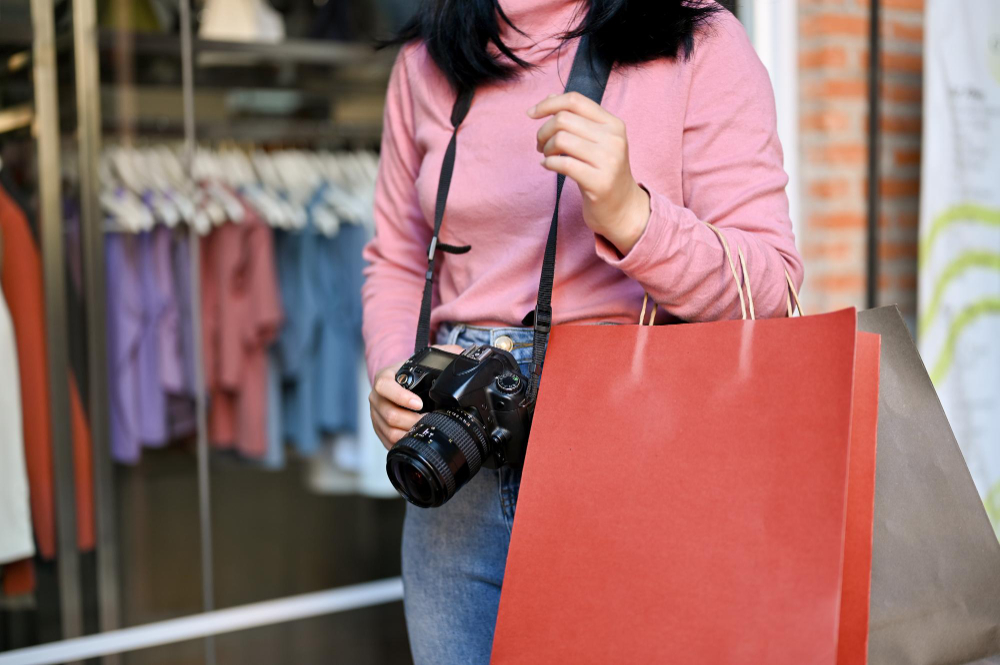photo-of-woman-walking-with-shopping-bag-and-camera-in-Scheveningen