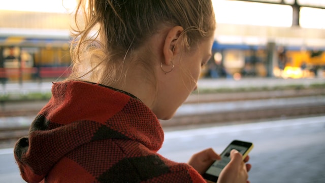 photo-of-woman-checking-public-transport-app-in-order-to-save-time-while-living-in-the-Netherlands