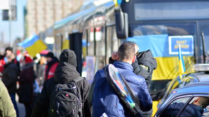 Ukrainian-refugees-standing-outside-a-bus