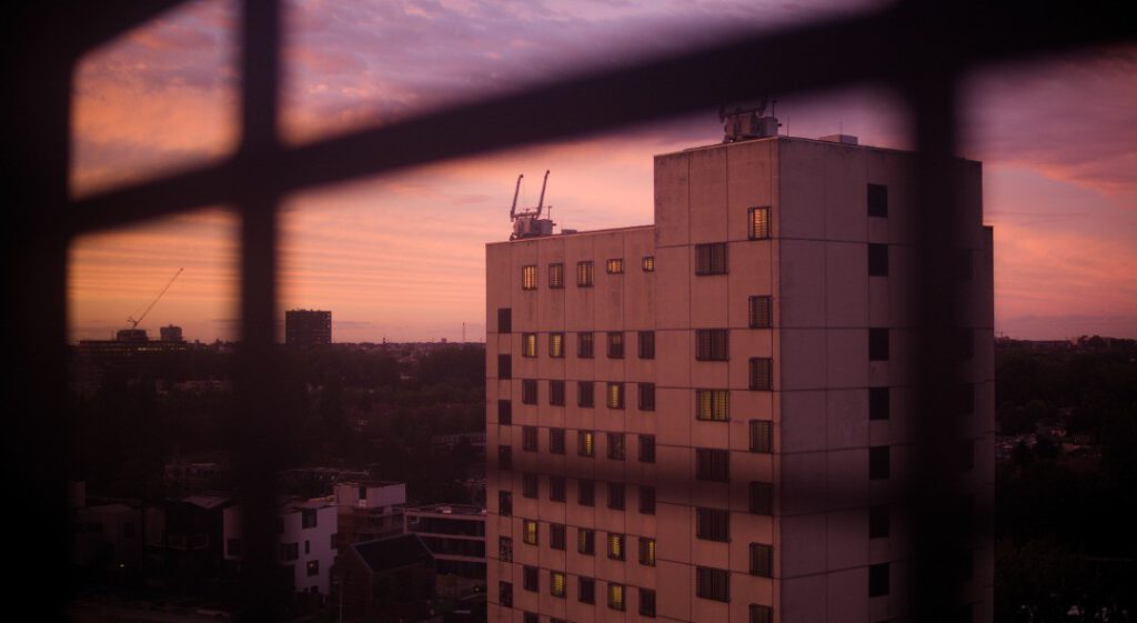 photo-of-the-view-of-the-prison-block-during-sunset-behind-the-prison-cells-barred-windows