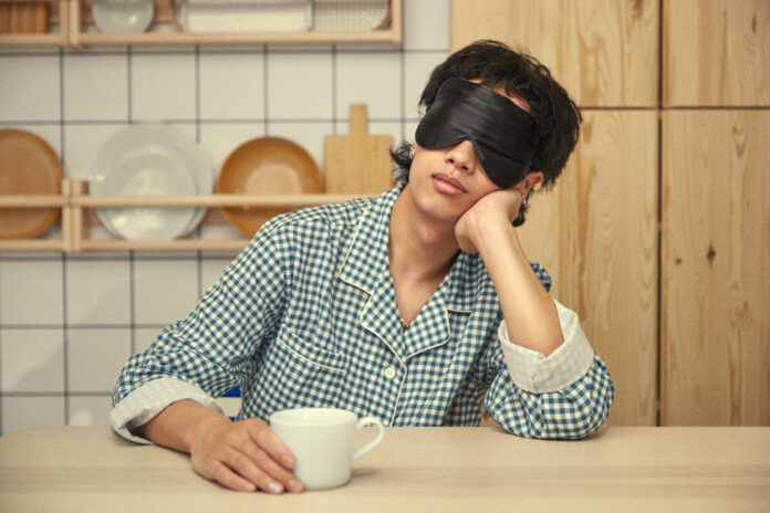 photo-of-person-sitting-at-table-in-ikea-wearing-pyjamas-and-face-mask