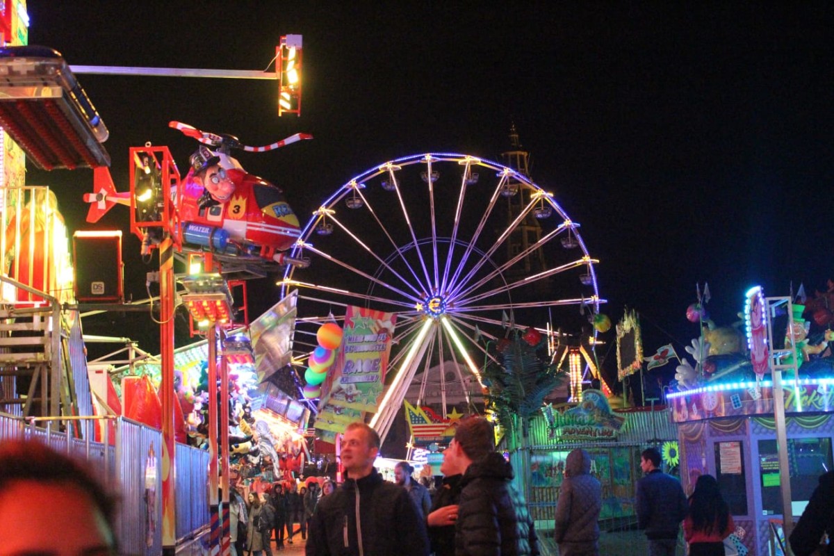 Photo-of-lit-ferris-wheel-and-attractions-at-funfair-in-Groningen-the-netherlands