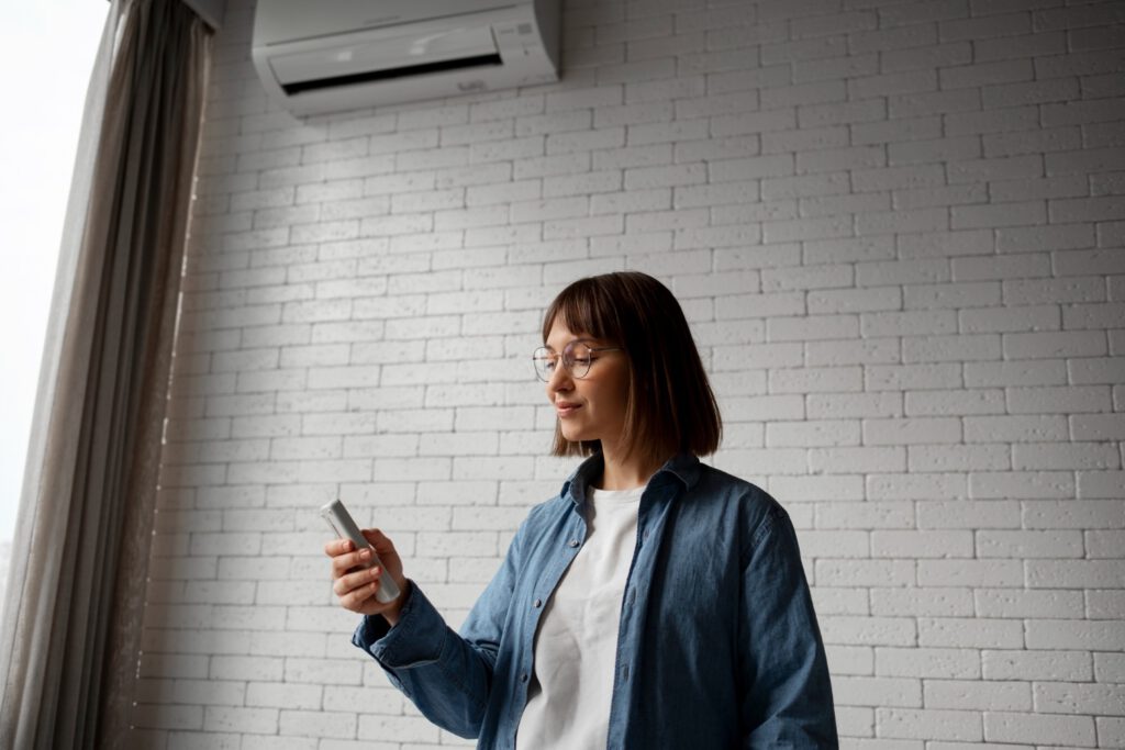 photo-of-woman-holding-remote-using-air-conditioning-in-the-Netherlands