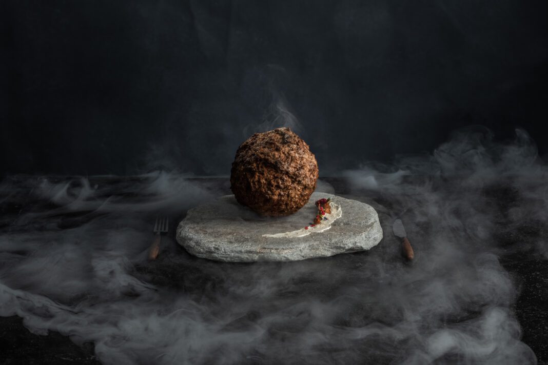 Lab-grown-wolly-mammoth-meatball-in-NEMO-Science-Museum-Amsterdam-on-plate-with-cutlery