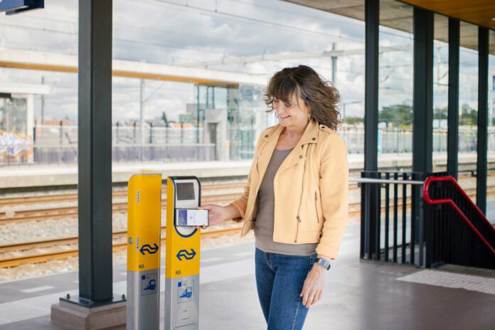Woman-checks-into-the-train-using-her-bank-card-in-the-Netherlands