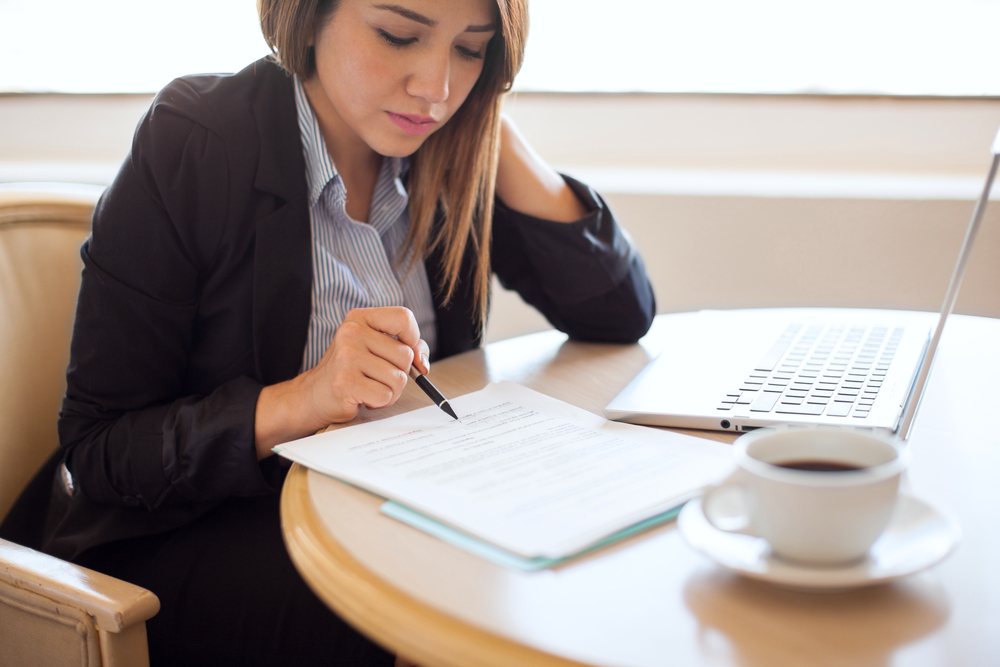 Woman-getting-ready-to-sign-a-contract-in-her-office