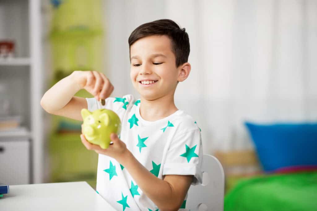 photo-of-
young-boy-putting-money-in-piggy-bank