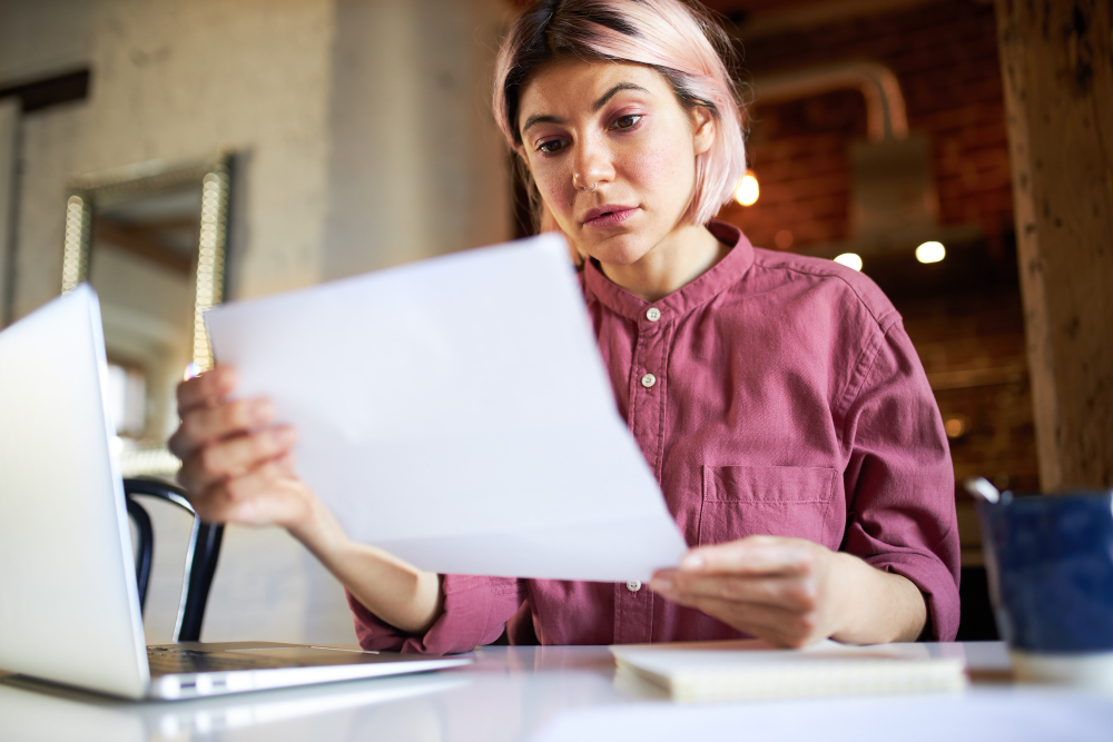 photo-of-woman-looking-confused-at-Dutch-rental-contract-after-landlord-over-charged-her-for-service-costs