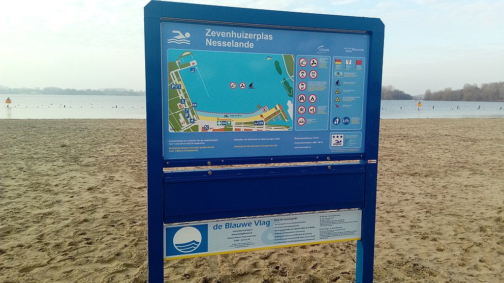 Map sign on the sandy beach of Zevenhuizerplas
