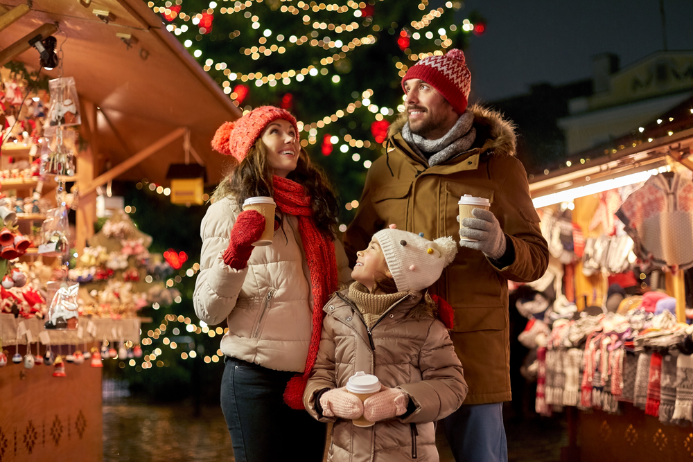 a-family-exploring-a-christmas-market-and-drinking-hot-chocolate