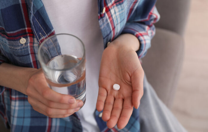 photo-of-woman-holding-abortion-pill-with-glass-of-water